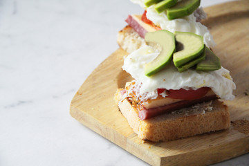 Cold cut sausage on wheat with Swiss cheese, tomato, egg and avocado