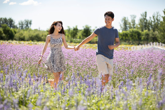Happy young couple in lavender field - Powered by Adobe