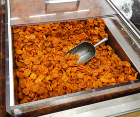 Dried apricots with a large metal spoon / scoop ready to be sold unpackaged to the environmentally...