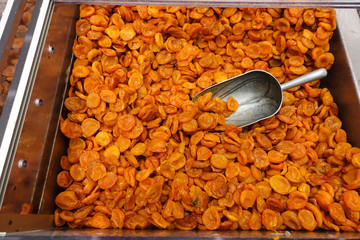 Dried apricots with a large metal spoon / scoop ready to be sold unpackaged to the environmentally...