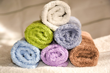 Fototapeta na wymiar terry colorful towels folded in rolls