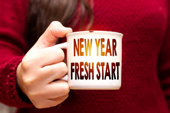 Hands Holding a Coffee Mug With Text New Year Fresh Start