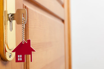 A key in a lock with house icon on it
