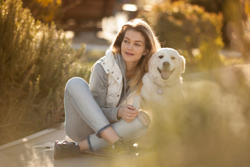 beautiful girl with a dog breed Golden Retriever best friends on a walk