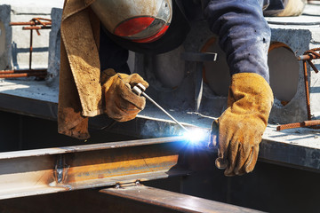 Worker welding in a factory. Welding on an industrial plant.