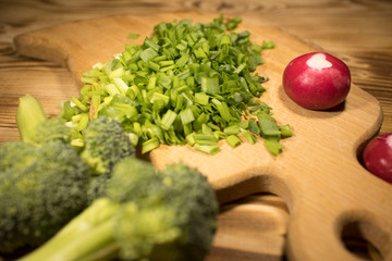 broccoli, chopped green onions, radishes on the table