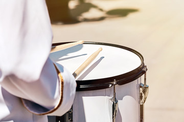 Closeup of a drummer's hand from an ensemble of drummers