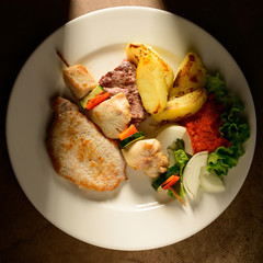 Mixed Grilled meat and vegetables decorated on a plate ready to be served in restaurant