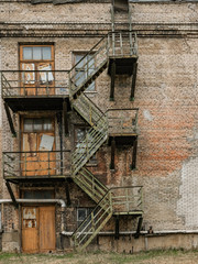 Old rusty fire escape on an abandoned industrial building