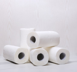 Pile of paper towels on the white marble surface against white wooden wall