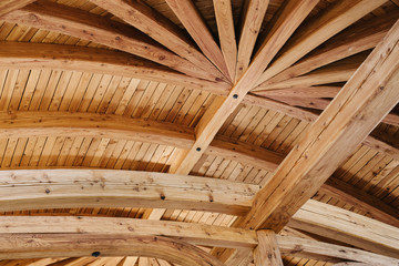 Part of the wooden architecture of the building interior. The wood-paneled ceiling with wooden...