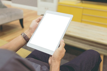 Mockup tablet on businessman hands empty display on home table with blur background. - Image - Image