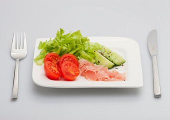 Salad with ham, cucumber, spinach, Bulgarian pepper. Black background.