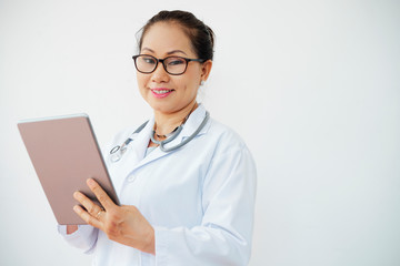 Positive female doctor with tablet computer