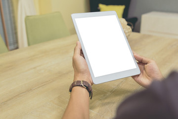 Mockup tablet on businessman hands empty display on home table with blur background. - Image - Image