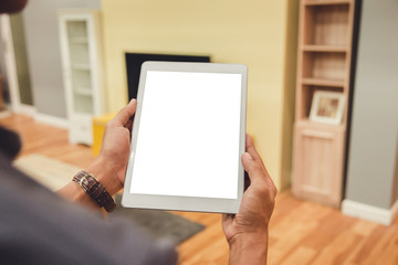 Mockup tablet on businessman hands empty display on home table with blur background. - Image - Image