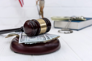 Selective focus on judge's gavel with american dollars