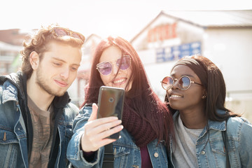 couple of multi-ethnic girls student doing a selfie with phone