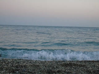 Genova, Italy - 04/22/2019: Close-up of big waves breaking on the coast in Liguria, Italy, Europe. White waves of the sea break on the cliff.