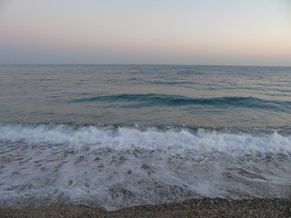 Genova, Italy - 04/22/2019: Close-up of big waves breaking on the coast in Liguria, Italy, Europe. White waves of the sea break on the cliff.