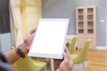 Mockup tablet on businessman hands empty display on home table with blur background. - Image - Image