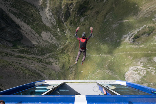 a man doing base jump with a parachute from a car at the pic du midi, Occitanie, Bagnères-de-Bigorre, France
