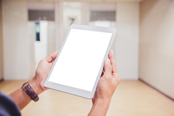Mockup tablet on businessman hands empty display on home table with blur background. - Image - Image