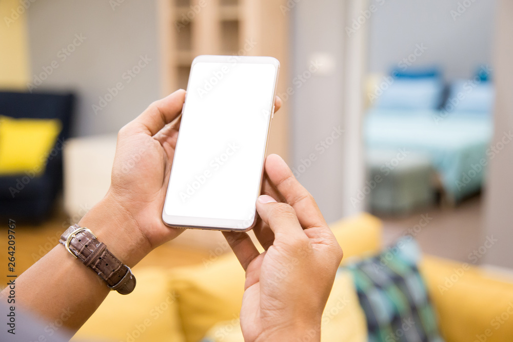 Poster mockup smartphone on businessman hands empty display on home table with blur background. - image - i