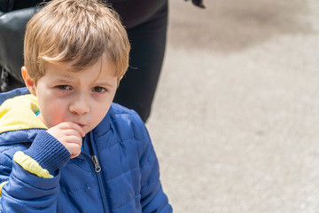 Small child eating popcorn in a park