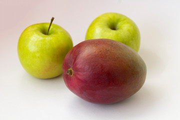 Apple and mango on white background
