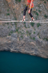 The Mimi Guesdon feet walking in heels on a highline above the Red Lake, Split-Dalmatia, Imotski,...