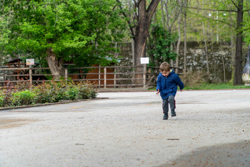 Fototapeta na wymiar Small child running in a park