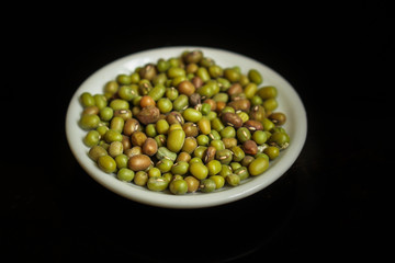 mung beans, mash. green beans in a white plate on the table. top food background. copy space