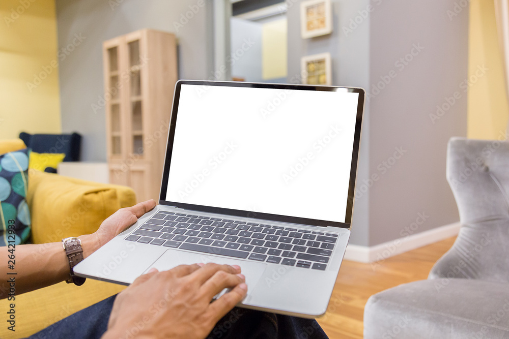 Wall mural mockup image of a businessman using laptop with blank white desktop screen working in home- image