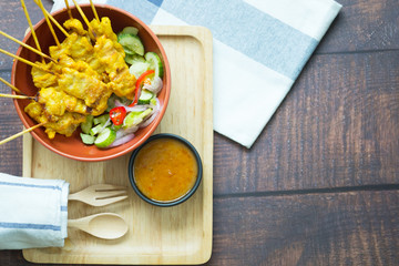 Pork satay with peanut sauce decorated with cucumber sauce, Thai food