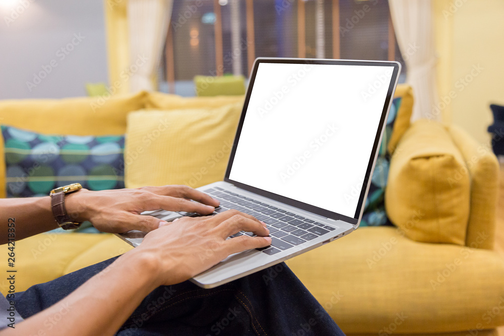 Sticker mockup image of a businessman using laptop with blank white desktop screen working in home- image