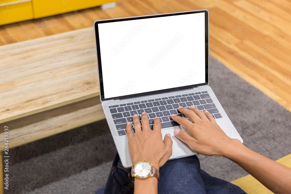 Poster mockup image of a businessman using laptop with blank white desktop screen working in home- image