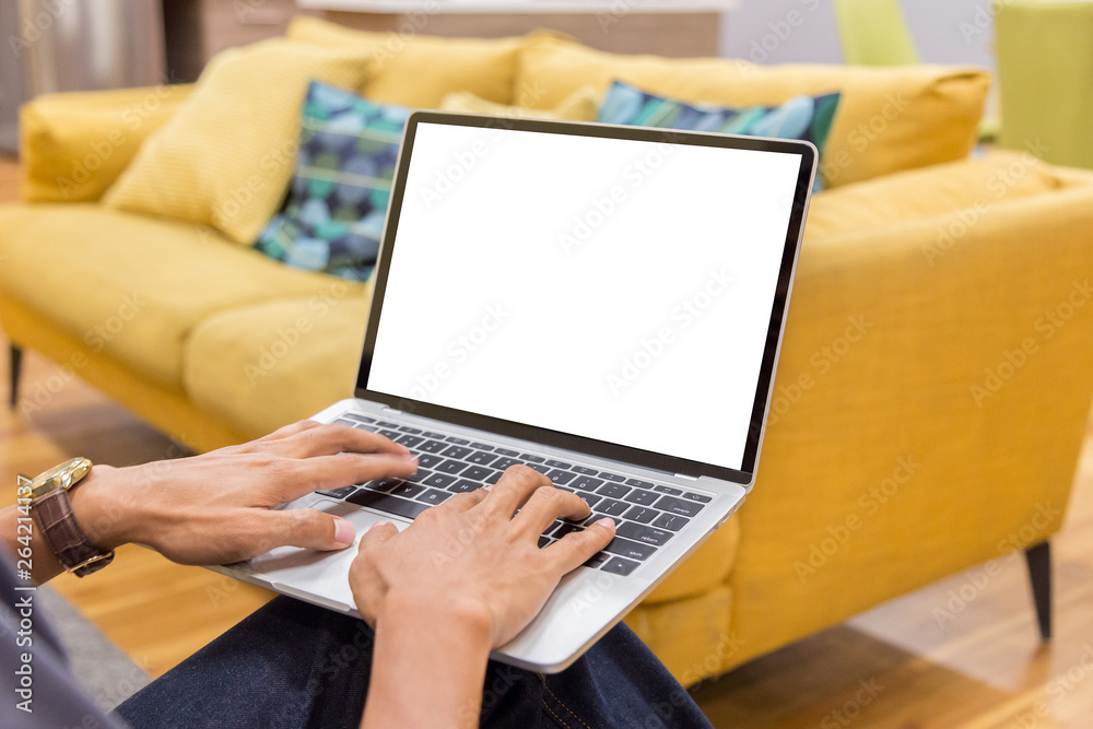 Wall mural mockup image of a businessman using laptop with blank white desktop screen working in home- image