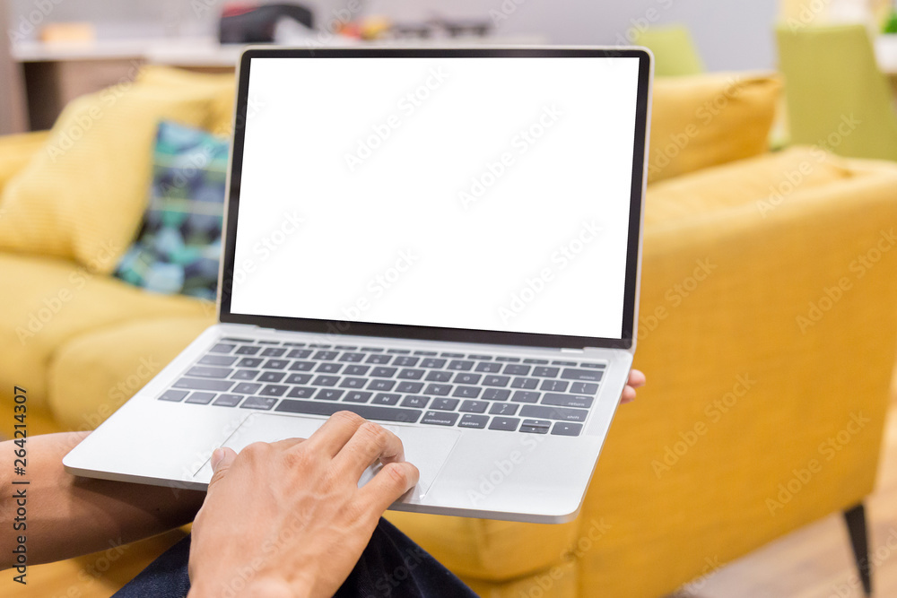 Wall mural mockup image of a businessman using laptop with blank white desktop screen working in home- image