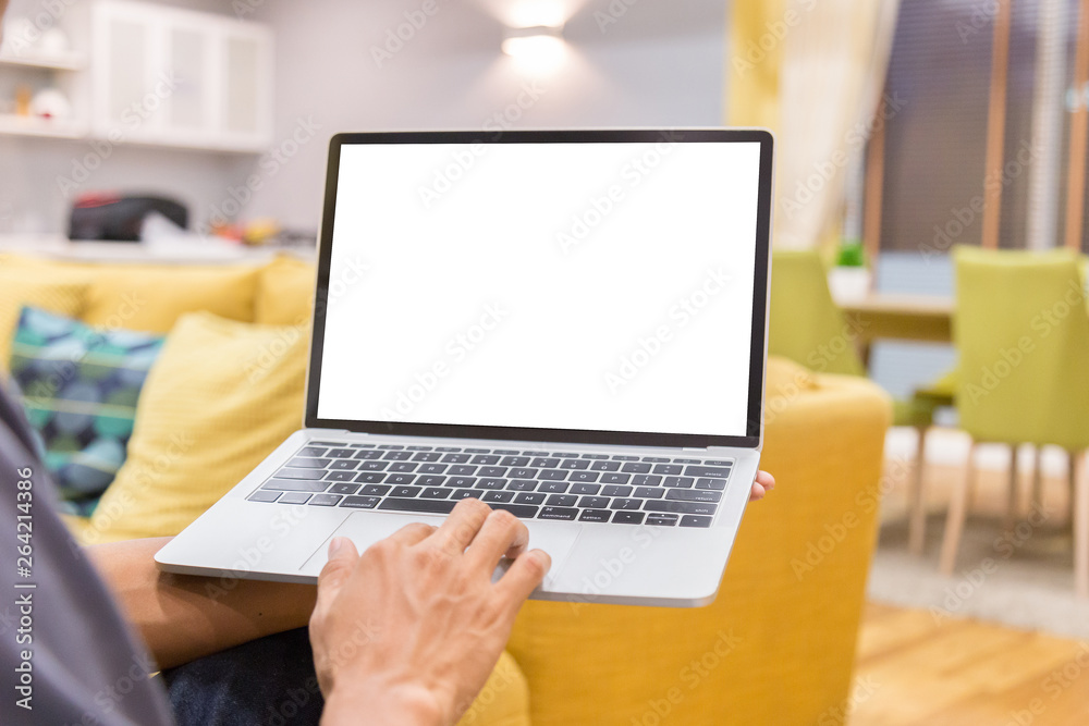 Sticker mockup image of a businessman using laptop with blank white desktop screen working in home- image