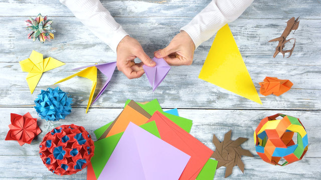 Hands Doing Origami Swallows. Person Making Plane From Colorful Paper. How To Fold A Super Easy And Quick Origami Birds.