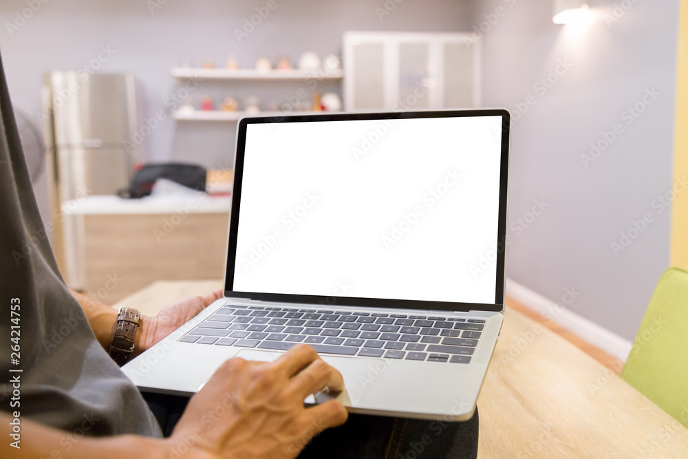 Poster mockup image of a businessman using laptop with blank white desktop screen working in home- image