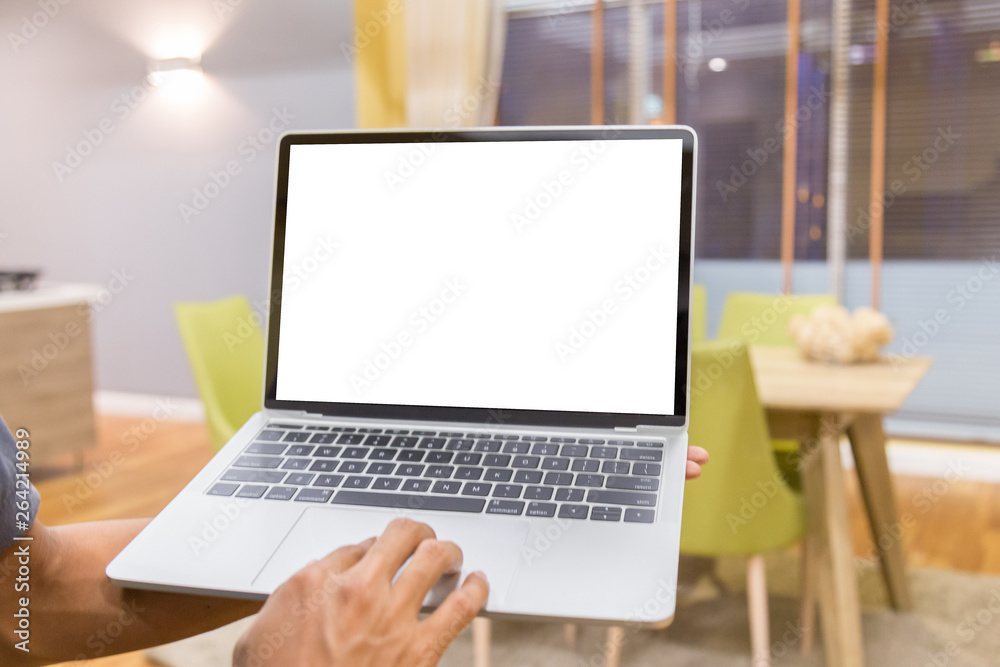 Wall mural mockup image of a businessman using laptop with blank white desktop screen working in home- image