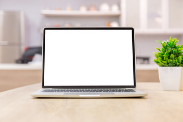 Fototapeta premium laptop showing blank screen on work table front view in home- Image