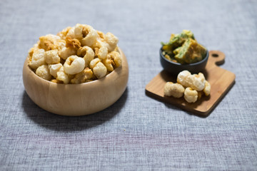 Pork rind in wooden bowl served with omelet