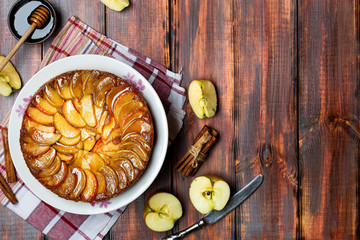 apple tart with caramel and cinnamon on wooden table