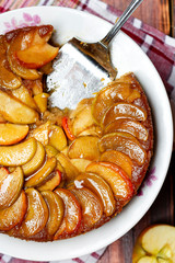 apple tart with caramel and cinnamon on wooden table