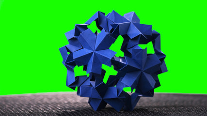 Spherical modular origami object. Blue origami figure on green screen. Creative origami project.