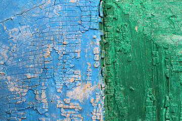 Obraz premium Old wooden background with remains of pieces of scraps of old paint on wood. Texture of an old tree, vintage wood background peeling paint. old blue board with cracked paint