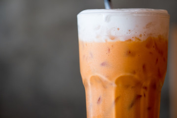Glass of Thai iced milk tea, blank for copy space.